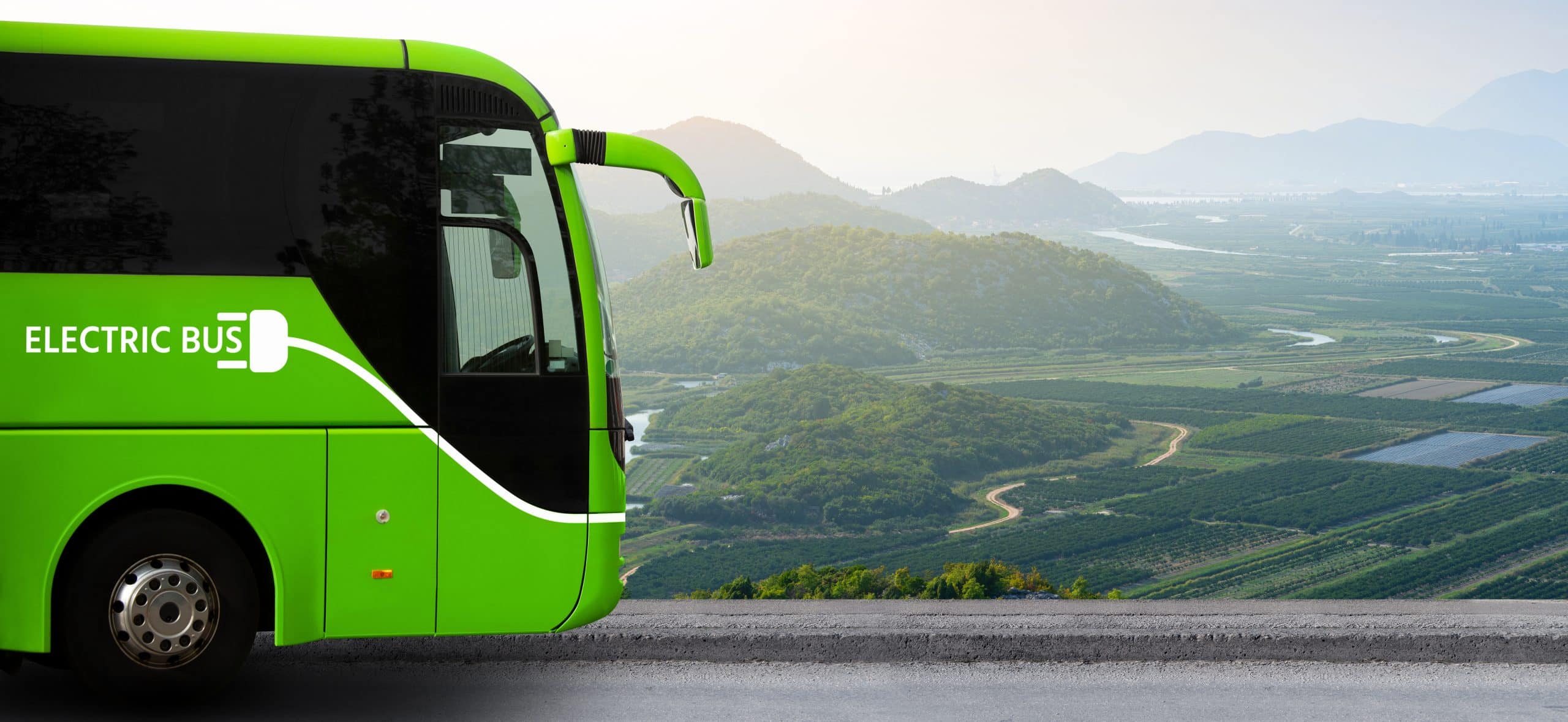 Electric,Tourist,Bus,In,Front,Of,Mountain,Valley